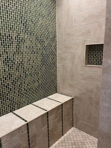 Shower with bench and vertical green mosaic feature wall